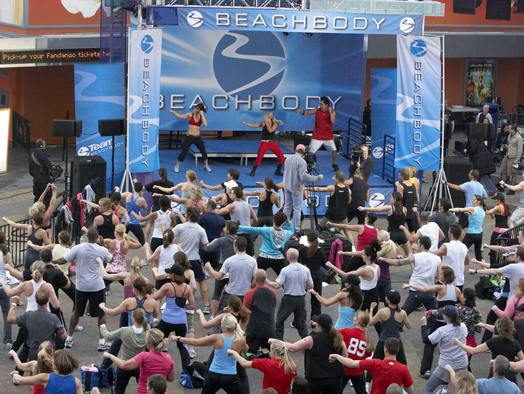 A beach body class on stage.